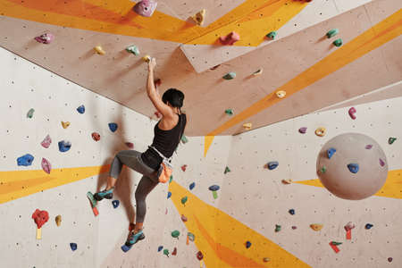 Woman making effort when climbing indoorsの写真素材