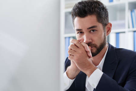 Portrait of handsome serious businessman looking at cameraの写真素材