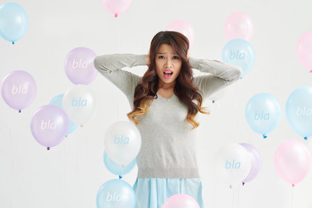 Unhappy woman with bla-bla-bla balloons around her