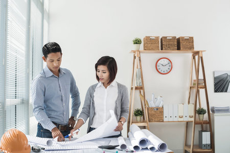 Architect working with blueprints in the office