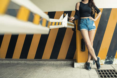 Cropped image of girl standing at black and yellow barrierの写真素材