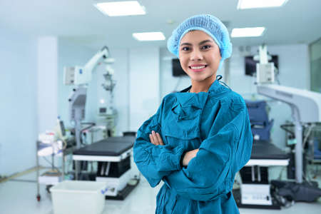 Beautiful smiling Vietnamese nurse in surgery roomの写真素材
