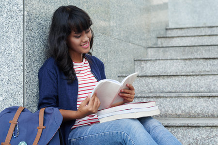 Young girl reading her notes and preparing for exams