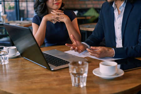 Businessman explaining his ideas to female partnerの写真素材