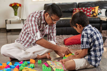 Father and son playing building blocks togetherの写真素材