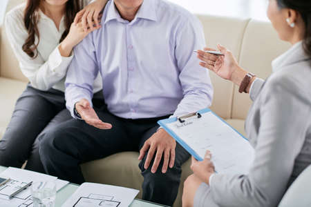 Estate agent concluding a contract with coupleの写真素材