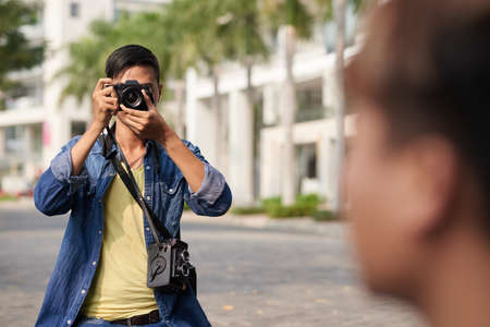 Photographer taking photo of model in the streetの写真素材