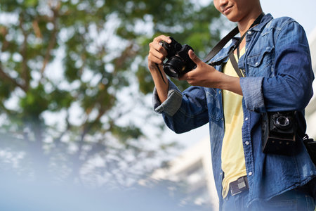 Cropped image of male photographer with professional camera