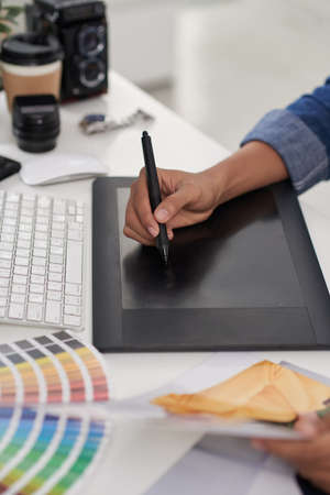 Cropped image of retoucher working on digital tabletの写真素材