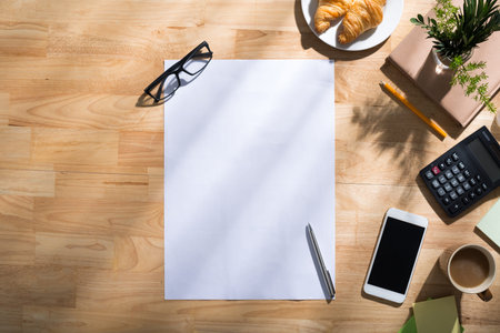 Blank sheet and a pen on table of business person