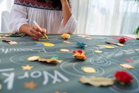 Woman working on motivational placard for herselfの写真素材