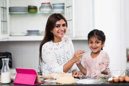Portrait of cheerful mother and her kid in kitchenの写真素材