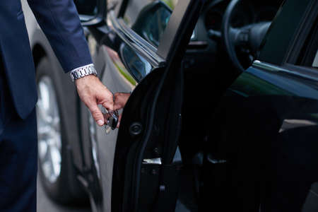 Cropped image of businessman opening door on his carの写真素材