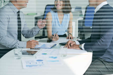 Asian business partners having meeting in officeの写真素材