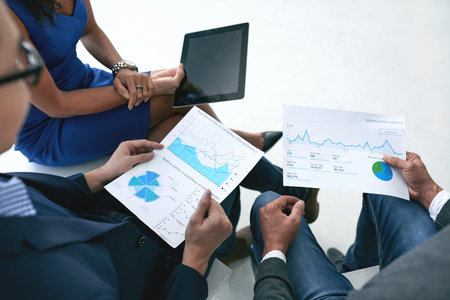 Business people discussing financial reports at meeting