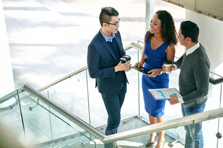 Smiling business partners talking during coffee breakの写真素材