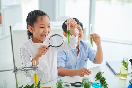 Cheerful children looking at plants in test-tubesの写真素材