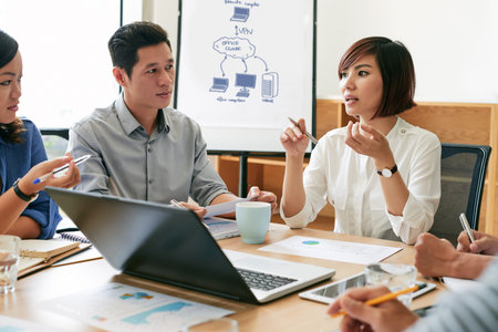 Young Asian business woman telling her ideas at meeting