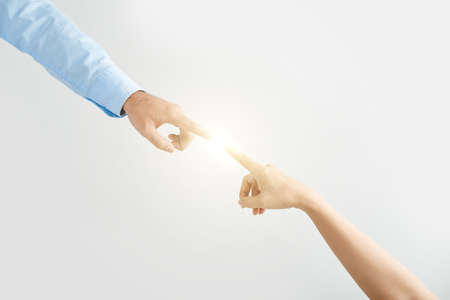 Close-up of couple hands touching the lightの写真素材