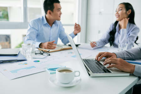 Young Asian business people discussing financial reportの写真素材