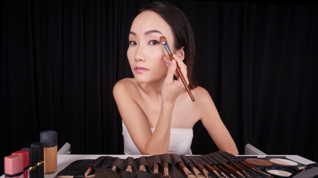 Young Chinese lady getting ready at her vanity
