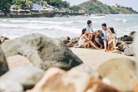 Group of friends enjoying time at the beachの写真素材