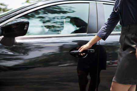 Cropped image of woman closing car doorの写真素材