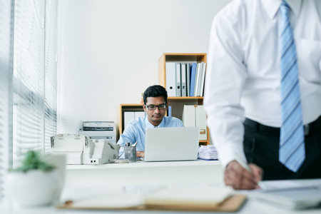 Indian business executive working on laptop at his table
