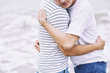 Happy gay couple in love standing outdoorsの写真素材