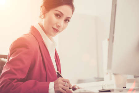 Pretty Asian business lady working with documentsの写真素材