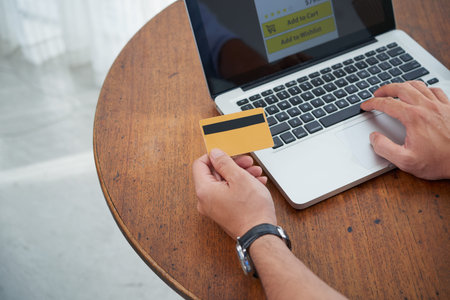 Hands of person paying with card for online purchase