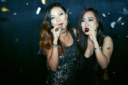Portrait of two attractive girls at the night partyの写真素材