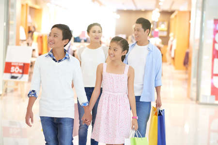 Vietnamese family making purchases in shopping mallの写真素材