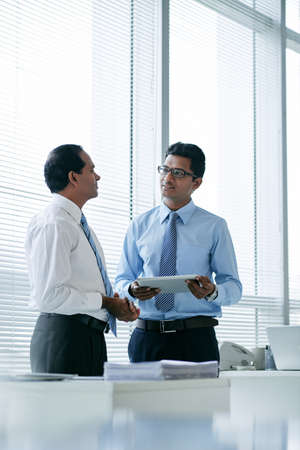 Two Indian business partners discussing new projectの写真素材