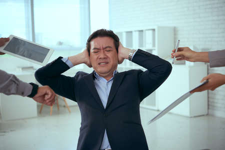 Portrait of Asian businessman tired of his workの写真素材