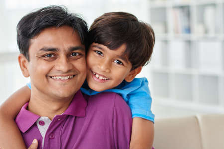 Portrait of smiling dad and his kid at homeの写真素材