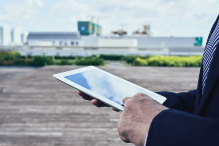 Close-up image of business executive using tablet computerの写真素材
