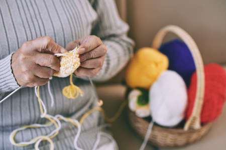 Hands of woman enjoying knitting at homeの写真素材