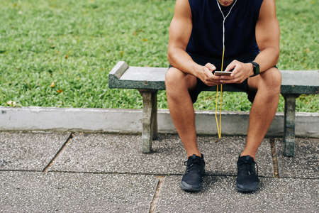 Cropped image of sportsman using application on his phoneの写真素材