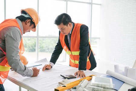 Engineers working on housing project in the officeの写真素材