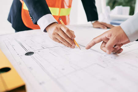Engineer explaining blueprint to the investor of projectの写真素材