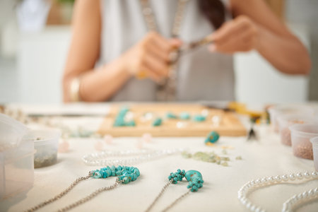 Woman creating her line of necklaces, selective focusの写真素材