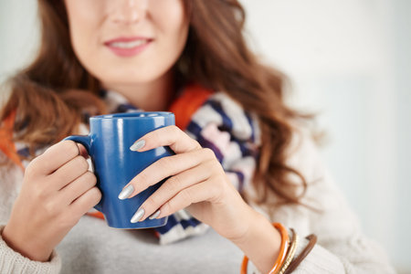 Cropped image of woman enjoying hot chocolateの写真素材