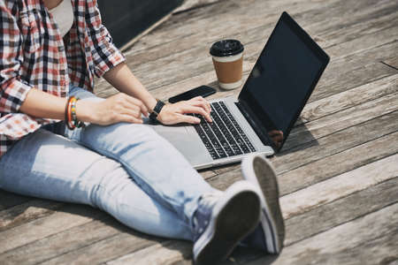 Cropped image of female student working on computerの写真素材