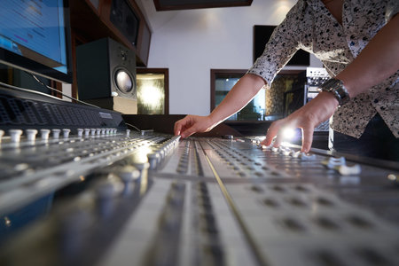 Hands of music writer working on soundboard