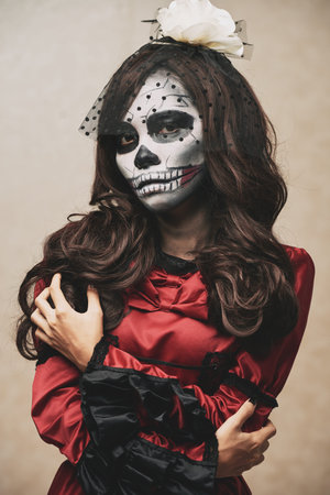 Sugar skull girl in black veil and beautiful dress