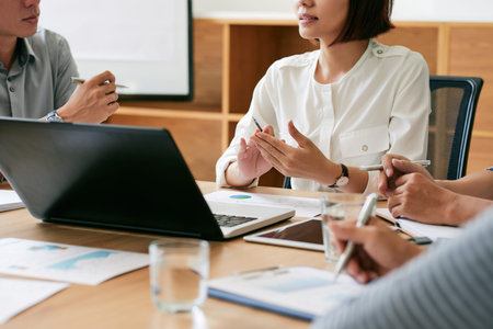 Cropped image of business team having meeting in office