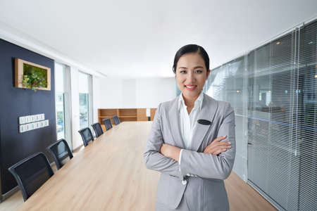 Pretty confident Vietnamese business woman standing in meeting roomの写真素材