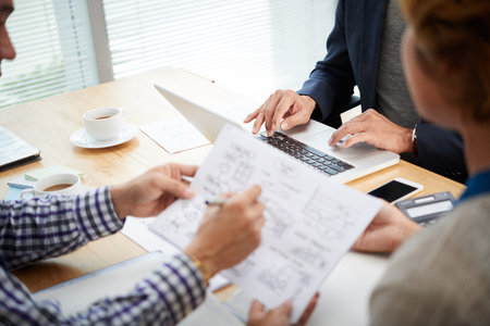 Hands of woman working on laptop during business meeting