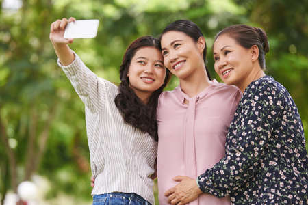Vietnamese girl photographing with mom and grandmaの写真素材